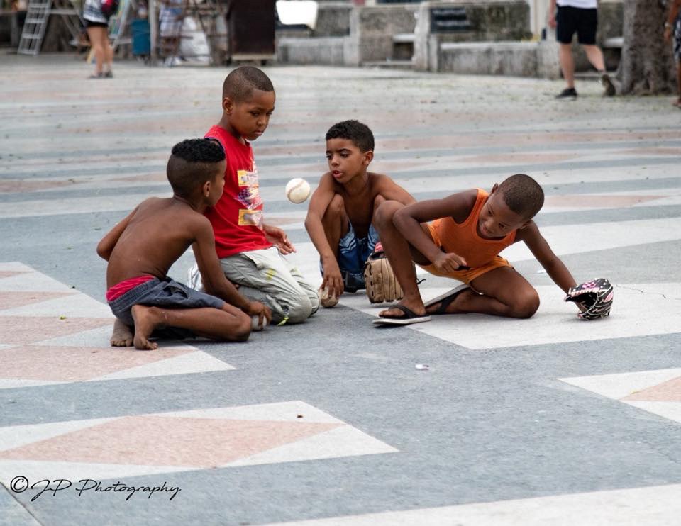 Cuban children playing with their baseball glove donations.