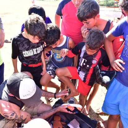 Cuban Children receiving gloves and baseball equipment dentations.