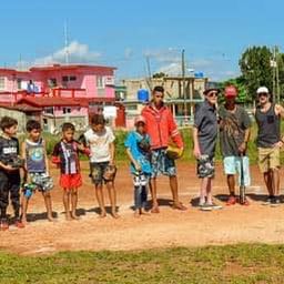 Cuban Children on a baseball field with their equipment.