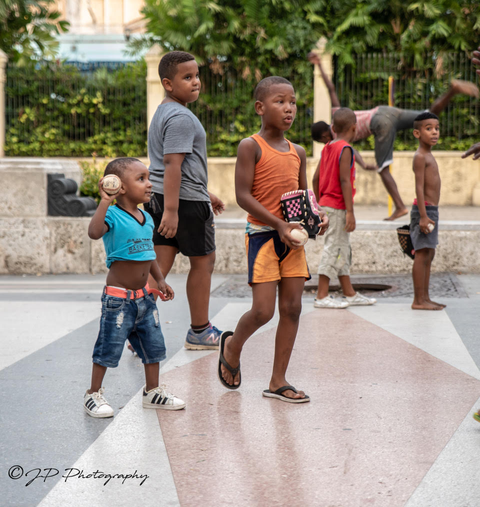Cuban children playing with their baseball glove donations.