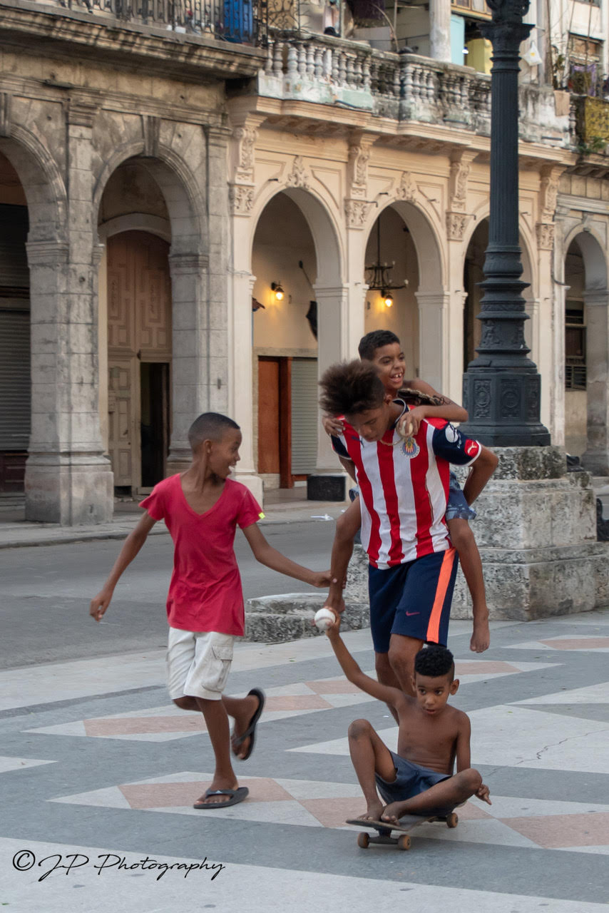 Cuban children playing with their baseball glove donations.