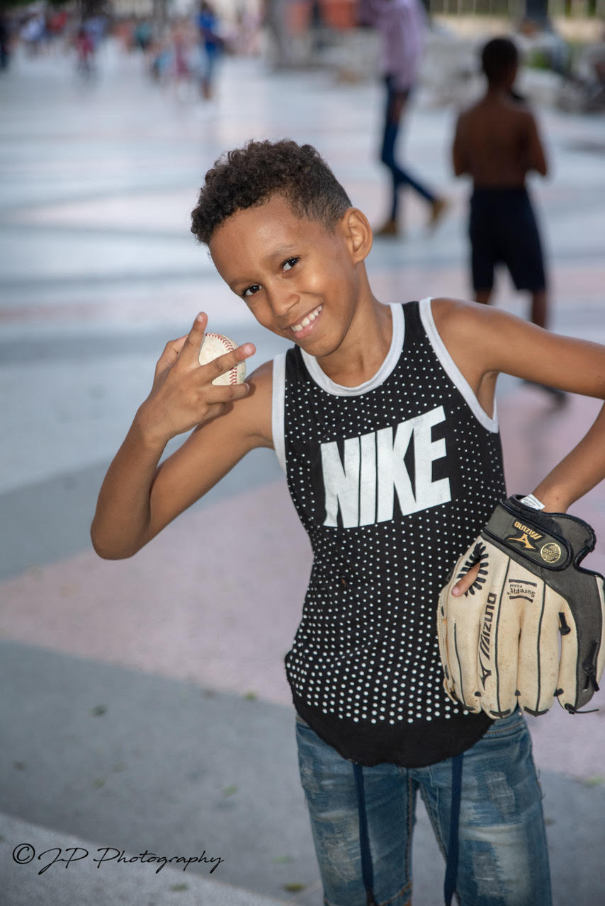 A Cuban Child smiling with his donated baseball glove.